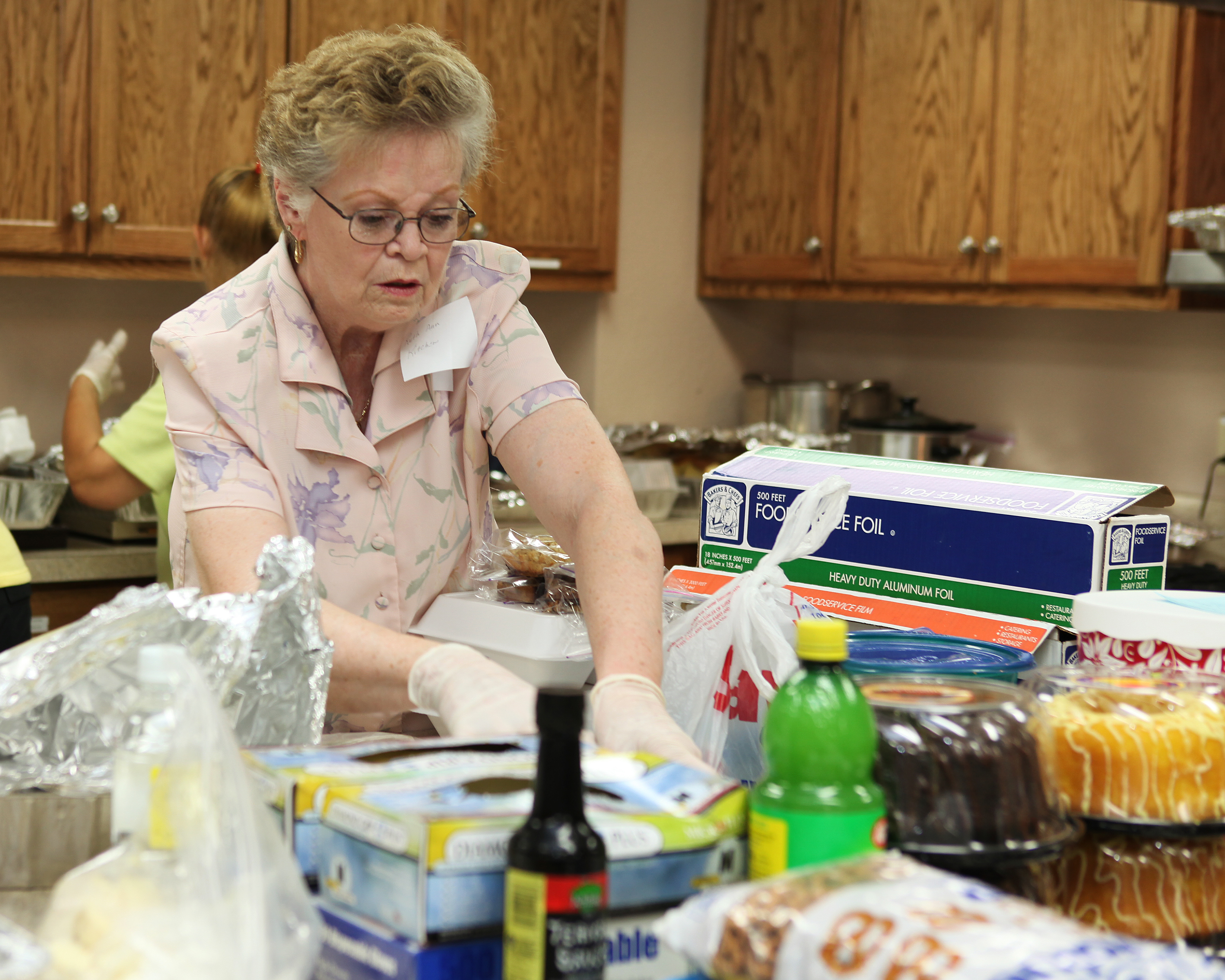 Volunteers working together in a kitchen to prepare meals.