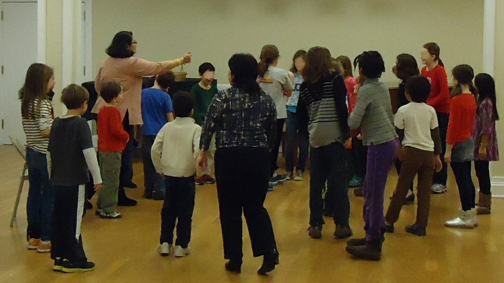Children and a youth leader gathered together in a church setting.